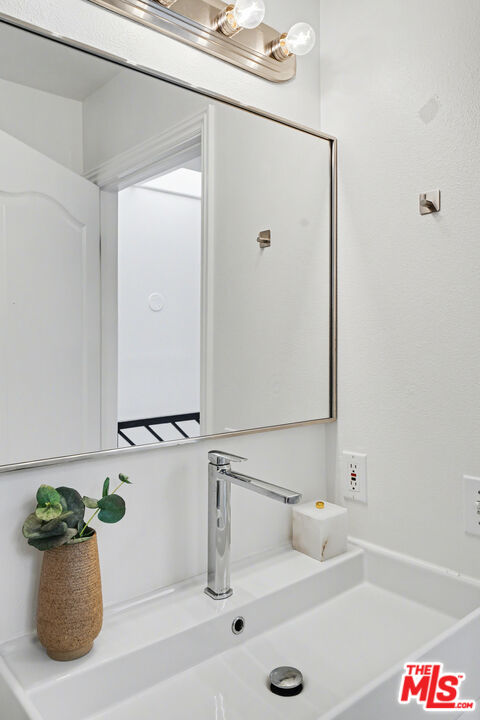 9917 Tabor Street, Unit 2 Los Angeles, CA 90034 - Photo 31 of 38 a bathroom with a sink and a window
