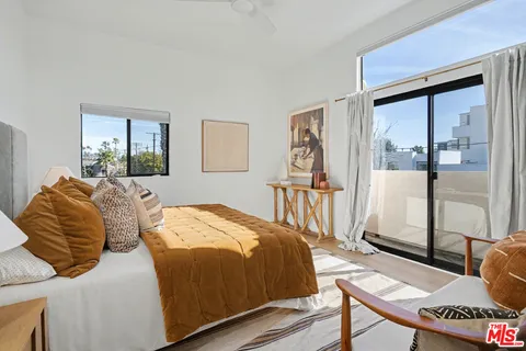 a bedroom with two beds and a window