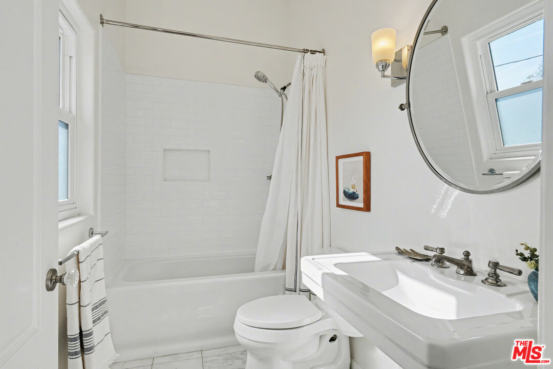 9917 Tabor Street, Unit 2 Los Angeles, CA 90034 - Photo 6 of 38 a bathroom with a sink toilet and shower