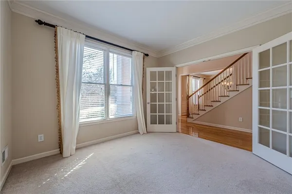 an empty room with closet and a ceiling fan