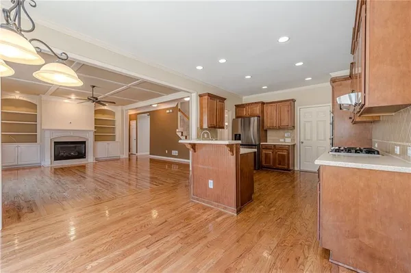 a view of a room with wooden floor and chandelier