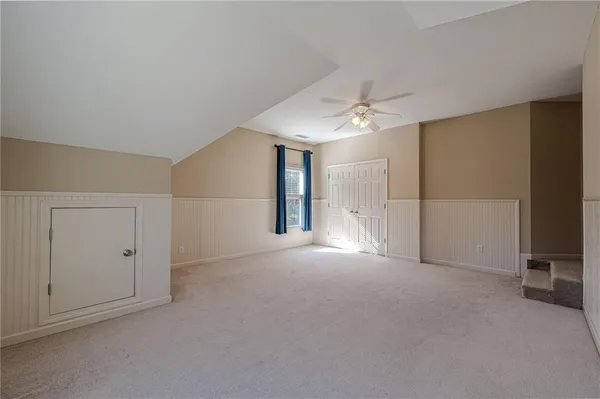 a view of empty room with wooden fence