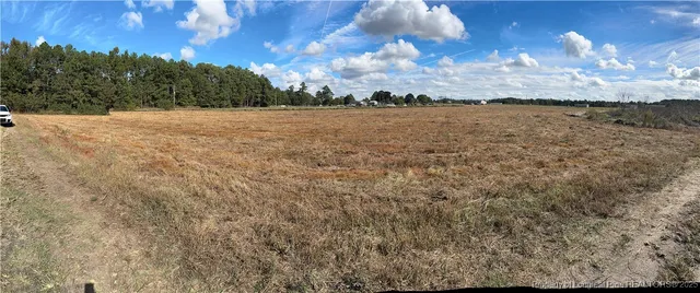 a view of mountain with sunset in background