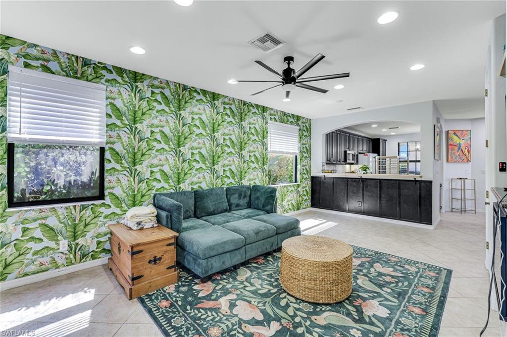 1307 Kendari Terrace Naples, FL 34113 - Photo 12 of 45 Living area with recessed lighting, ceiling fan, arched walkways, and wallpapered walls