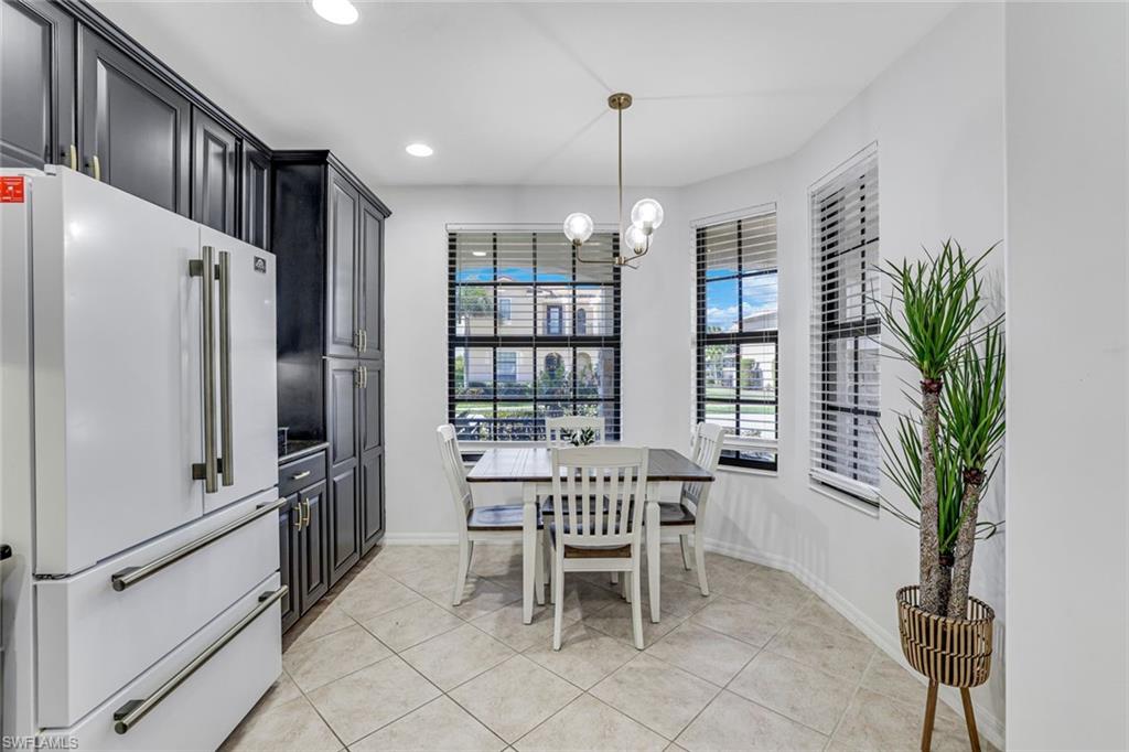 1307 Kendari Terrace Naples, FL 34113 - Photo 15 of 45 Dining room with light tile patterned floors and suspended lighting