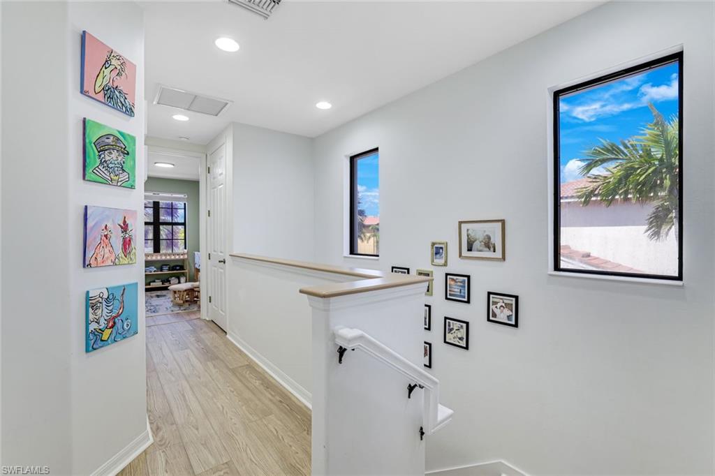 1307 Kendari Terrace Naples, FL 34113 - Photo 19 of 45 Hallway featuring an upstairs landing, light wood finished floors, and recessed lighting