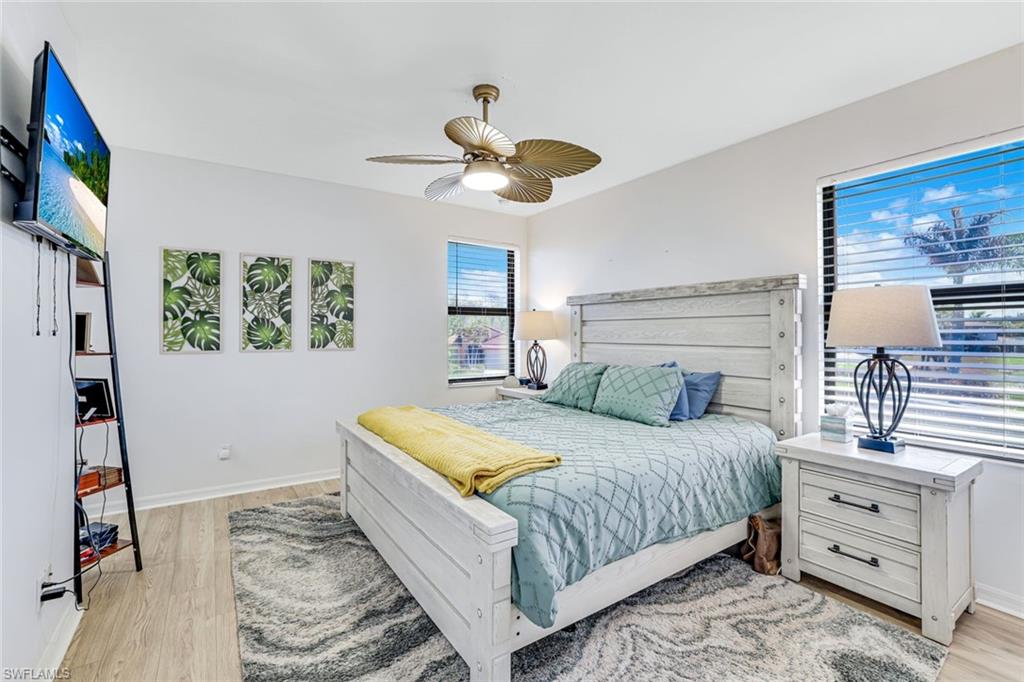 1307 Kendari Terrace Naples, FL 34113 - Photo 20 of 45 Bedroom featuring a ceiling fan and light wood finished floors
