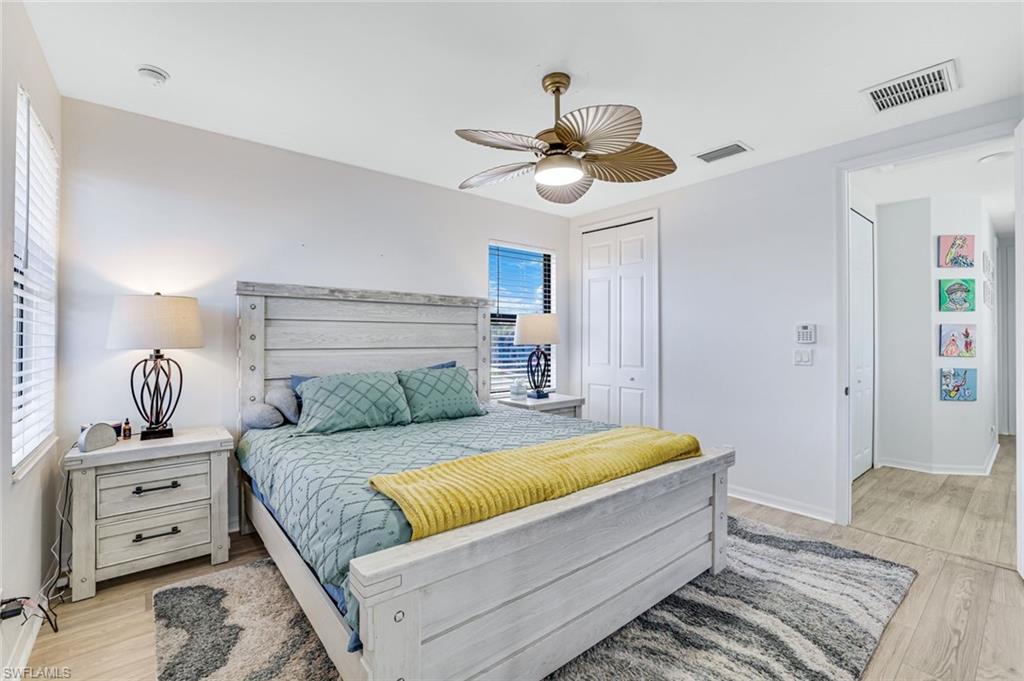 1307 Kendari Terrace Naples, FL 34113 - Photo 21 of 45 Bedroom featuring ceiling fan, a closet, and light wood-type flooring