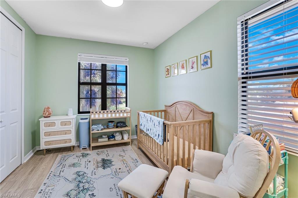 1307 Kendari Terrace Naples, FL 34113 - Photo 26 of 45 Bedroom with a nursery area, light wood finished floors, and a closet