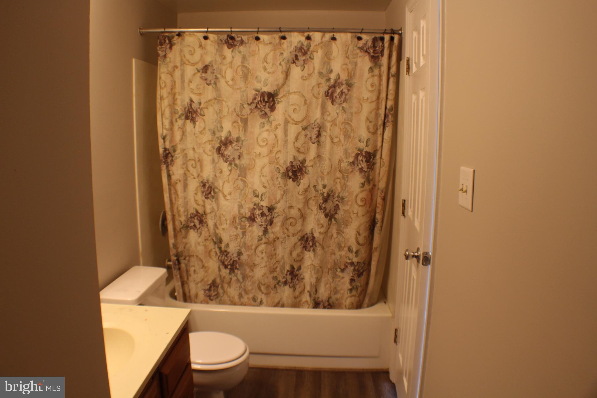 6308 Greenfield Road Elkridge, MD 21075 - Photo 12 of 14 a bathroom with a toilet and shower curtain