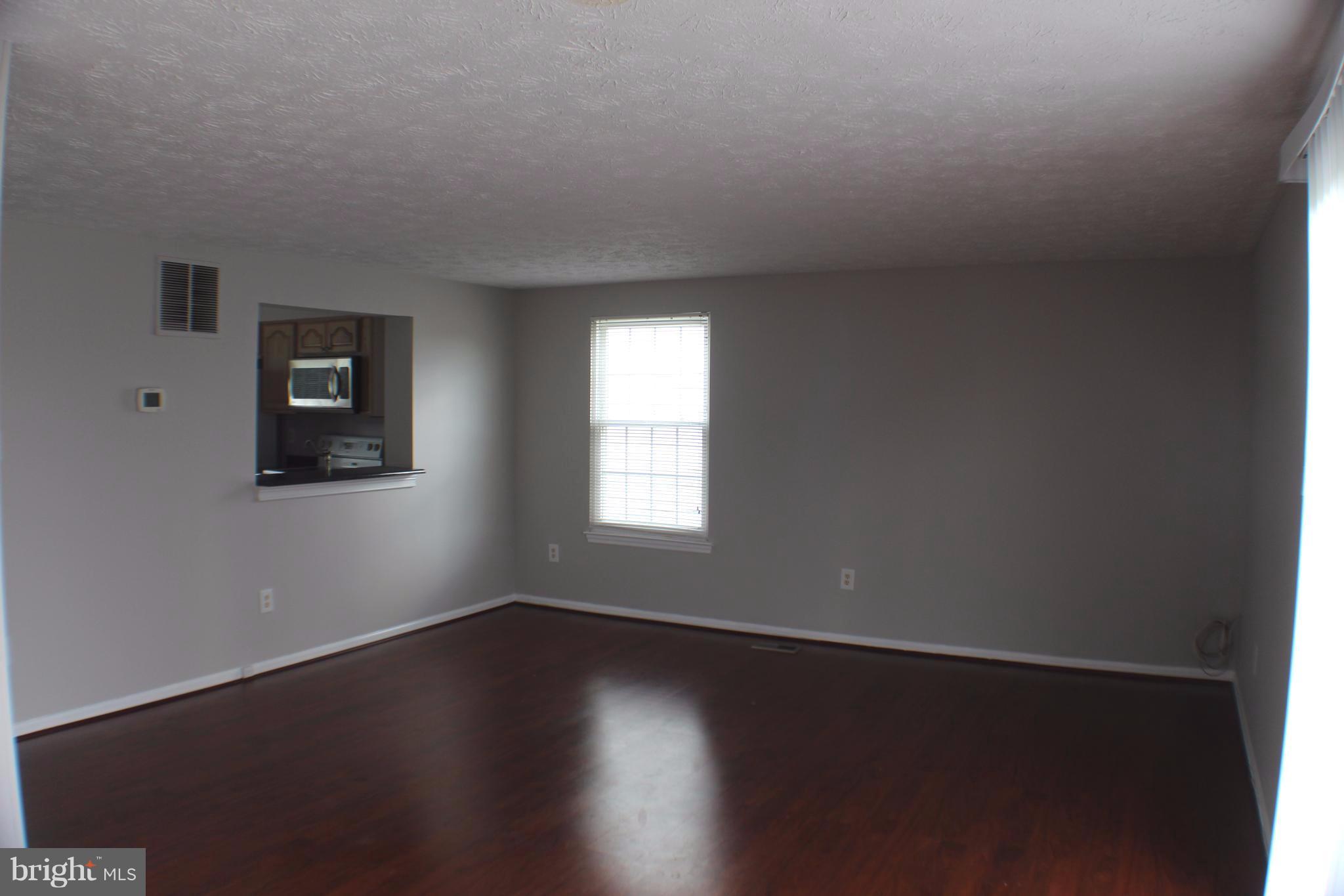 6308 Greenfield Road Elkridge, MD 21075 - Photo 6 of 14 a view of a room with wooden floor and windows