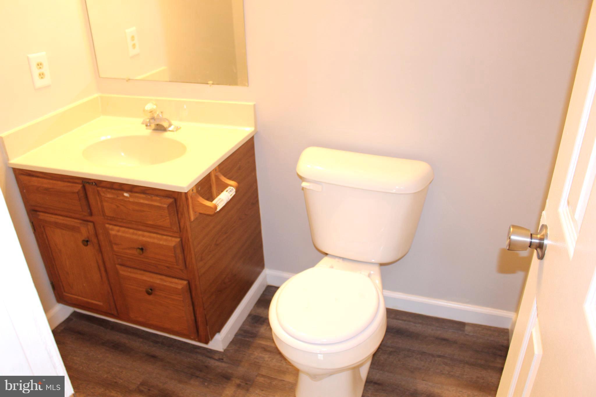 6308 Greenfield Road Elkridge, MD 21075 - Photo 7 of 14 a bathroom with a toilet sink and mirror