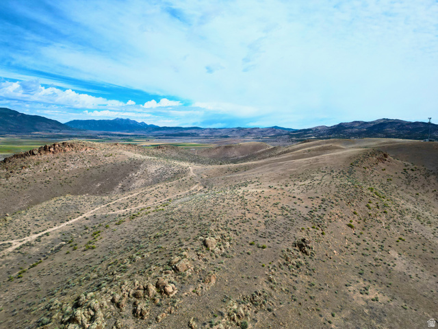 600 East E Street Moroni, UT 84646 - Photo 16 of 38 Expansive undeveloped land featuring rolling hills, natural rock formations, sparse vegetation, and distant mountain ranges