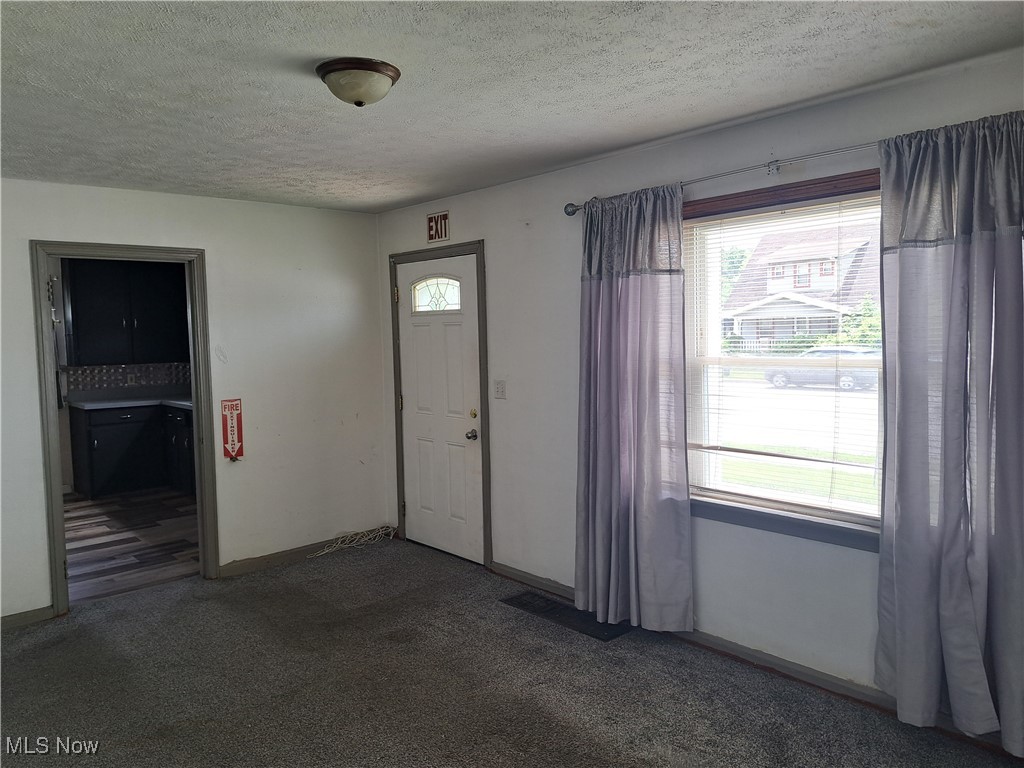 2239 North Ridge Road Lorain, OH 44055 - Photo 11 of 28 Carpeted foyer with a textured ceiling and baseboards