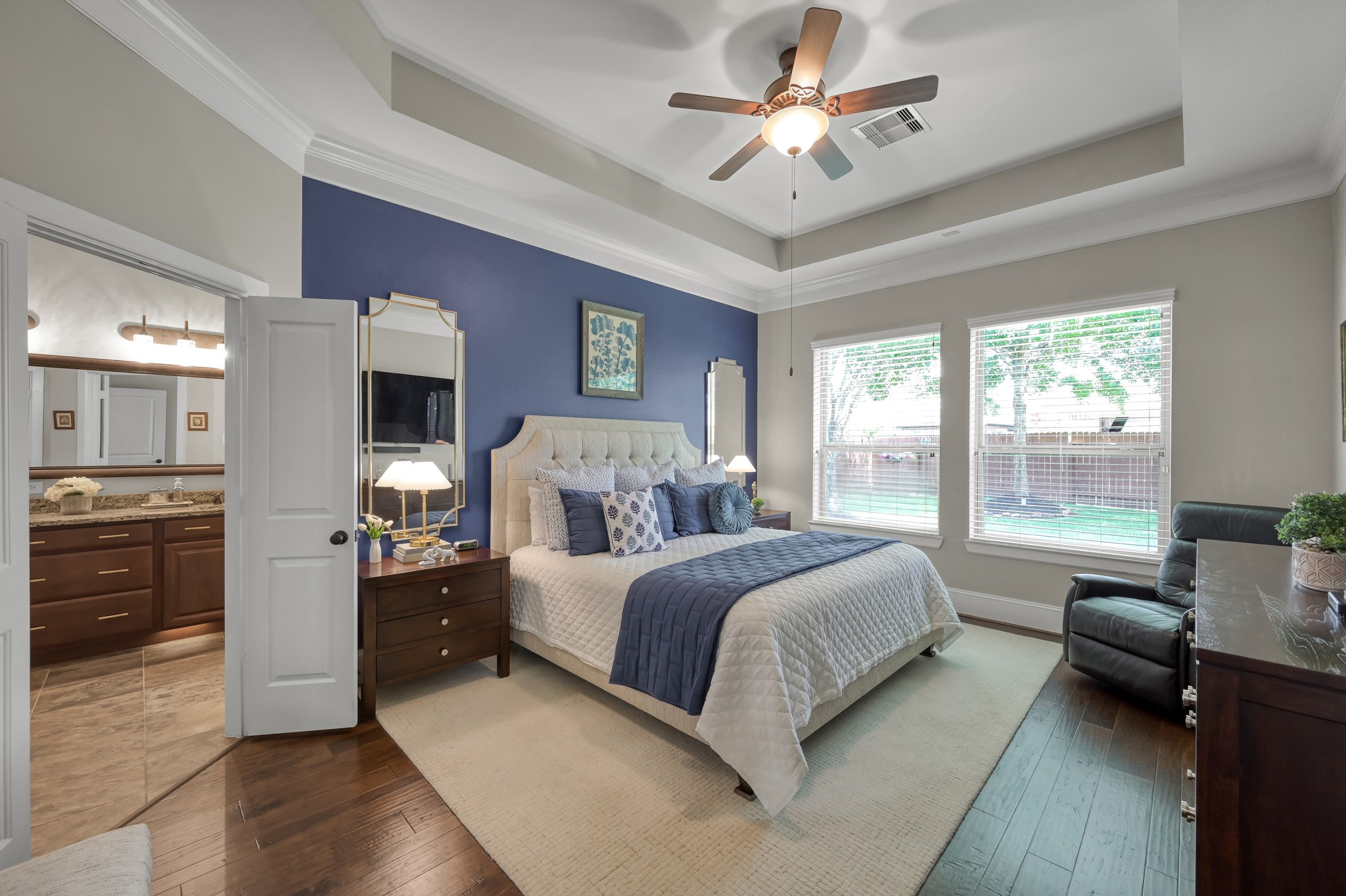 31742 Serrano Bluff Lane Spring, TX 77386 - Photo 12 of 40 Primary suite w/ coffered ceilings, wood flooring and custom paint.