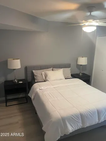 a bedroom with a bed and a lamp