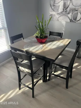 a view of a dining room with furniture and a potted plant