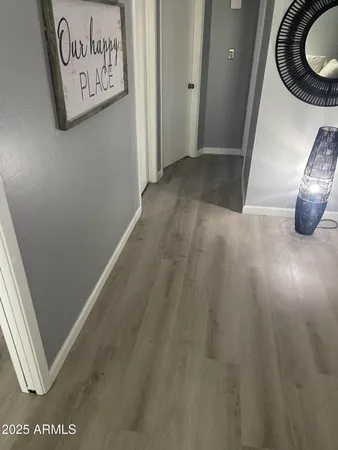 a view of a hallway with wooden floor