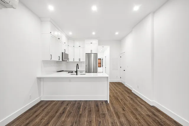 a view of kitchen with sink and wooden floor