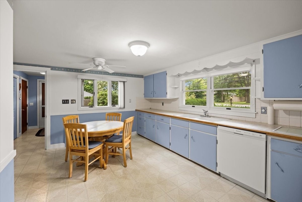 435 Sandwich Road Falmouth, MA 02536 - Photo 14 of 29 a kitchen with a sink and wooden cabinets