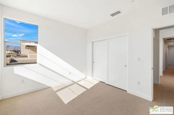 a view of wooden floor and windows in a room