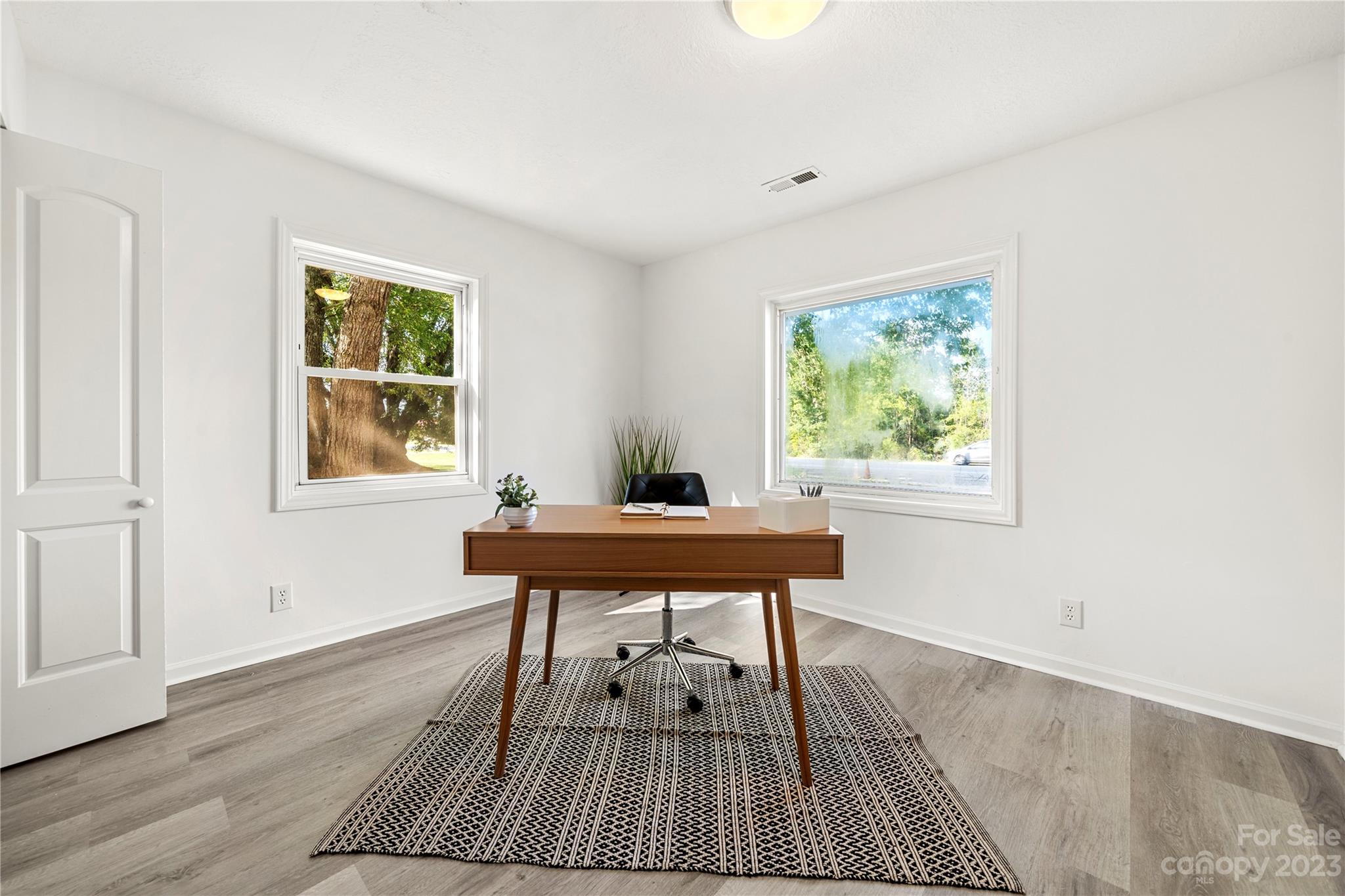 5836 Highway 601 Concord, NC 28025 - Photo 18 of 35 a workspace room with wooden floor table and windows