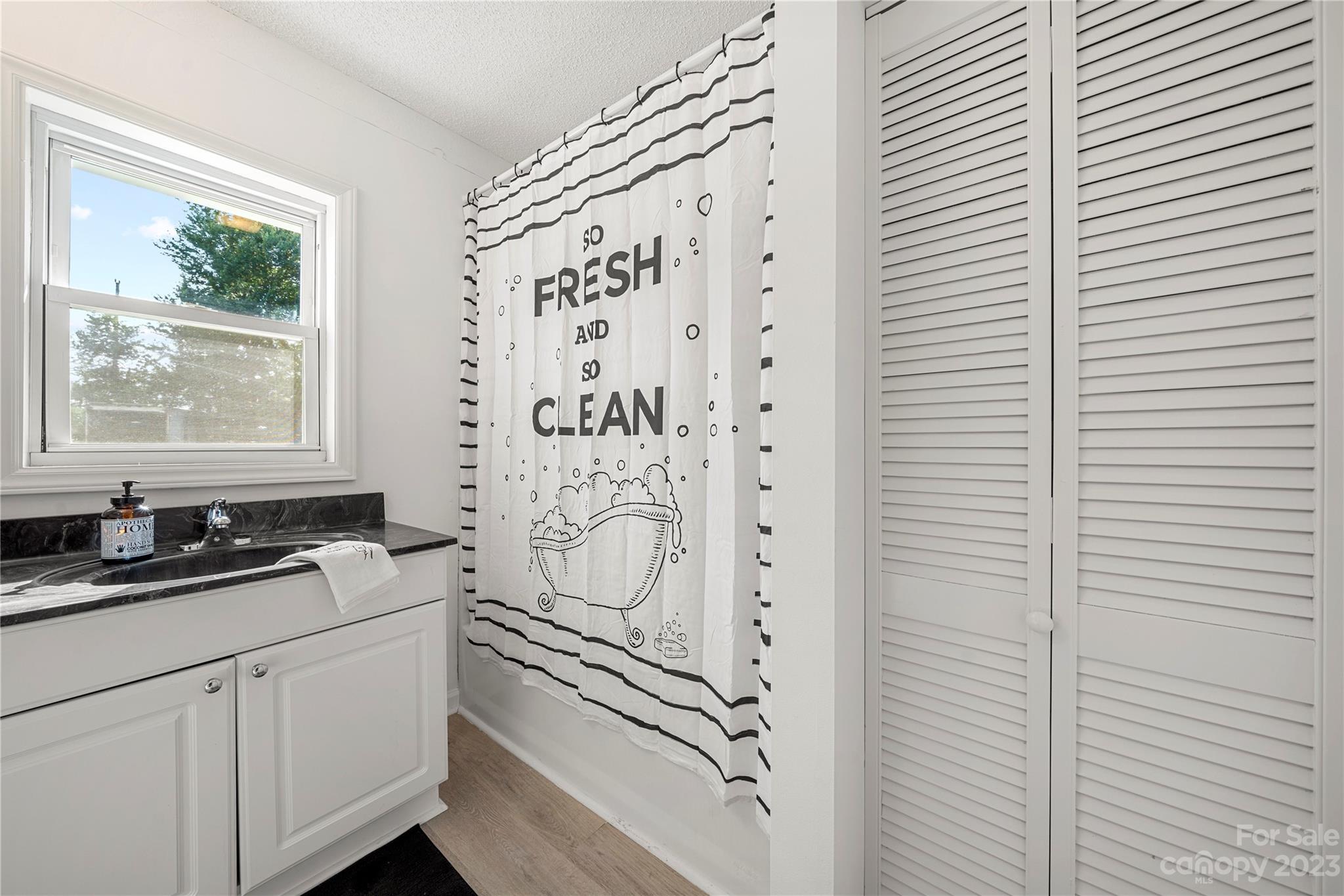 5836 Highway 601 Concord, NC 28025 - Photo 22 of 35 a bathroom with a sink a mirror and a shower