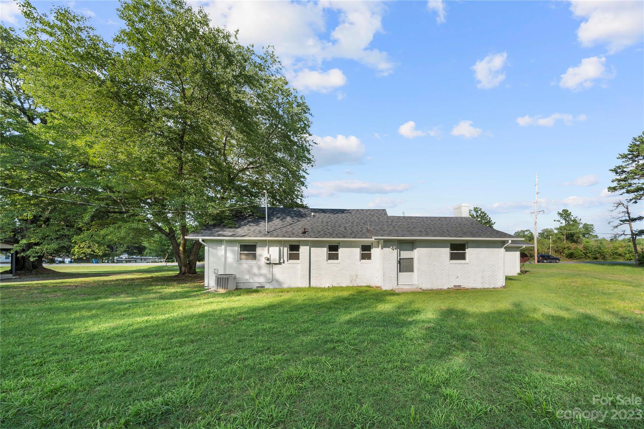 5836 Highway 601 Concord, NC 28025 - Photo 27 of 35 a front view of a house with a garden and yard