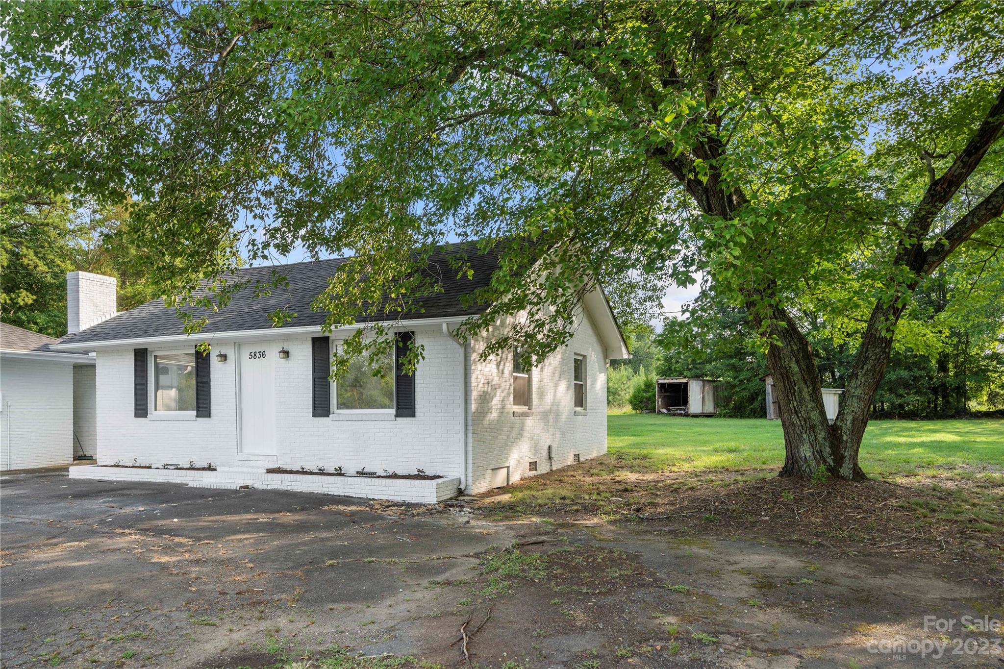 5836 Highway 601 Concord, NC 28025 - Photo 4 of 35 a front view of a house with a garden