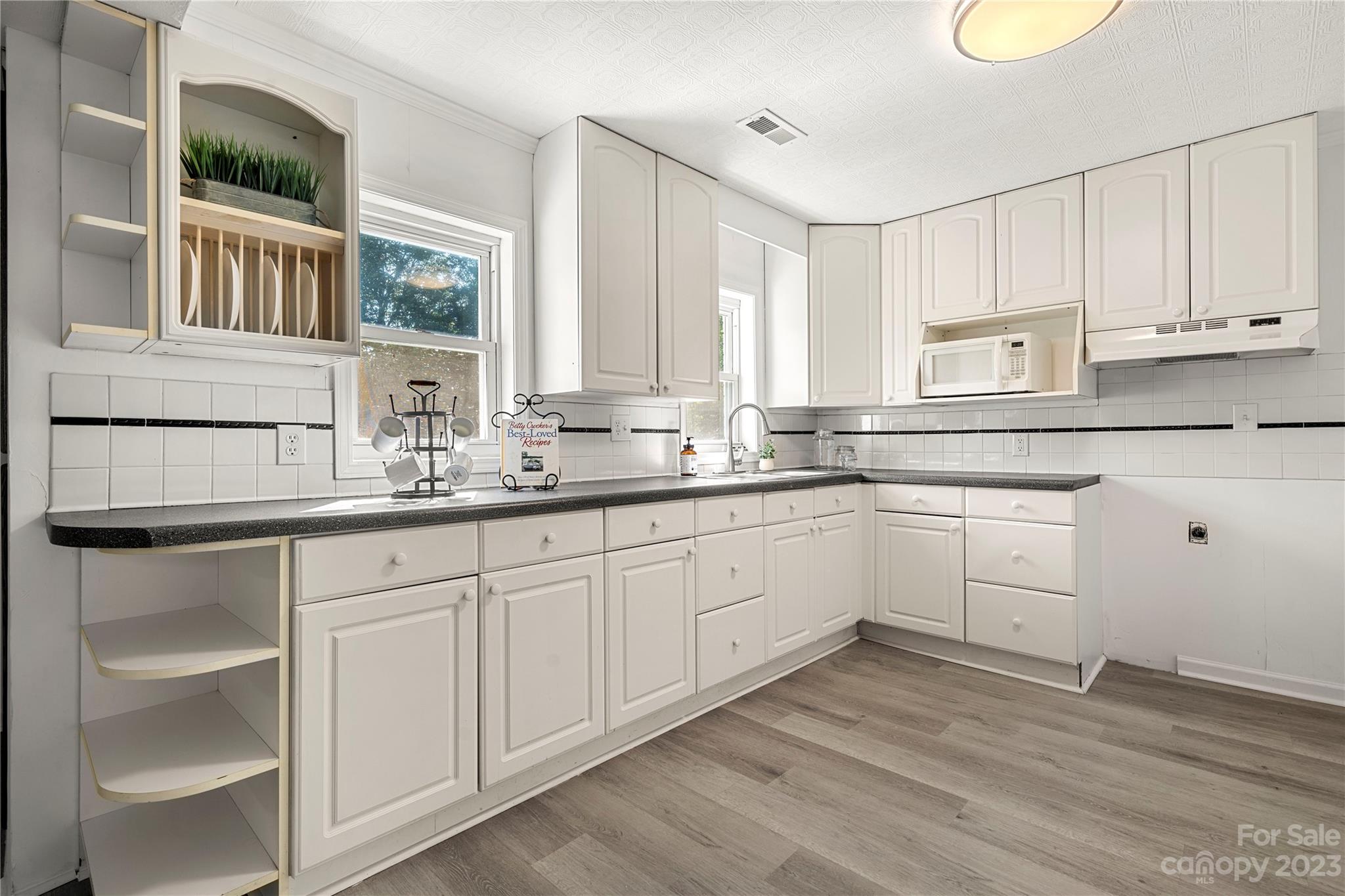 5836 Highway 601 Concord, NC 28025 - Photo 10 of 35 a kitchen with granite countertop white cabinets and white appliances