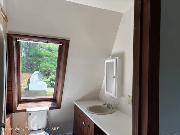 a bathroom with a sink and a window