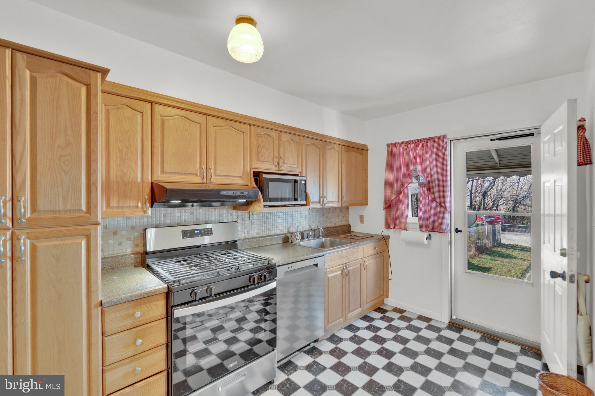7723 Charlesmont Road Baltimore, MD 21222 - Photo 9 of 28 Kitchen with Oak Cabinetry