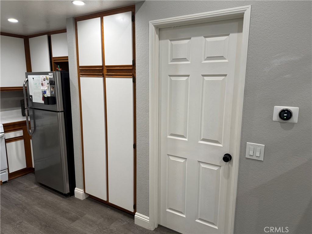 23 Pomelo Rancho Santa Margarita, CA 92688 - Photo 12 of 28 a view of a kitchen with refrigerator and wooden floor