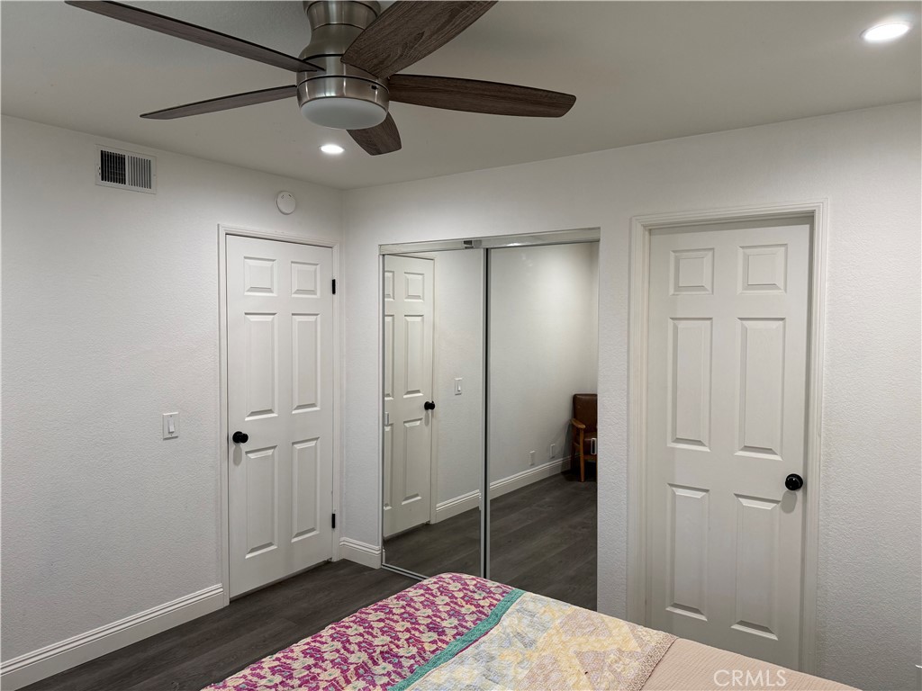 23 Pomelo Rancho Santa Margarita, CA 92688 - Photo 16 of 28 a bedroom with a walk in closet and wooden floor