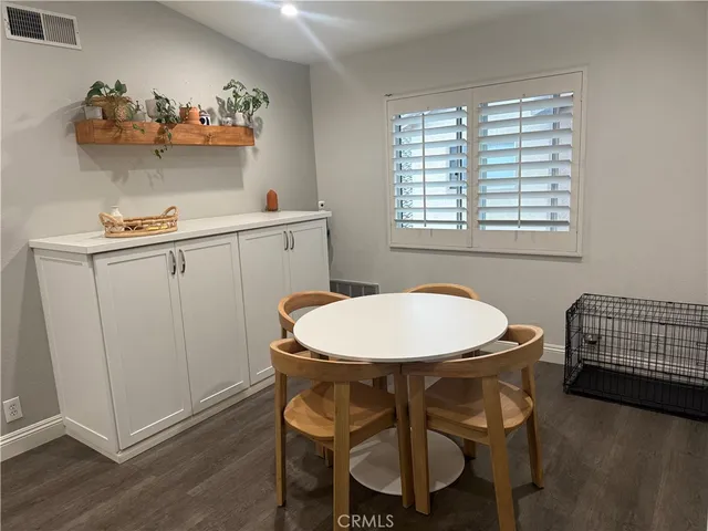 a view of a dining room with furniture and chandelier