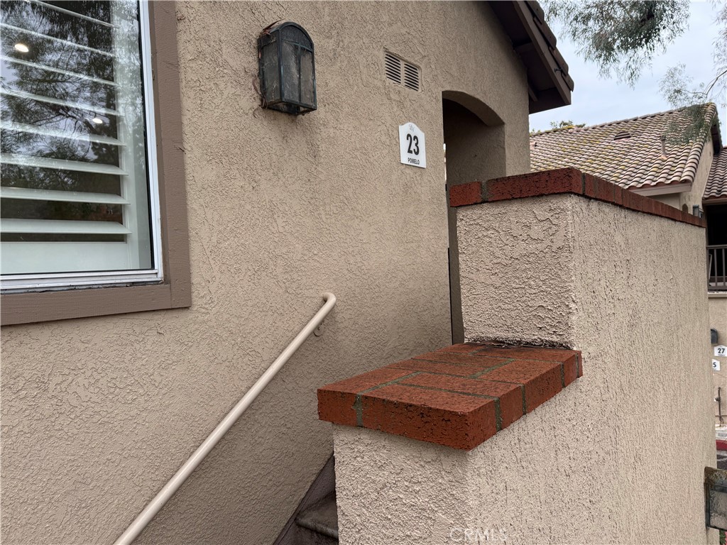 23 Pomelo Rancho Santa Margarita, CA 92688 - Photo 3 of 28 a wooden bench sitting in front of a door
