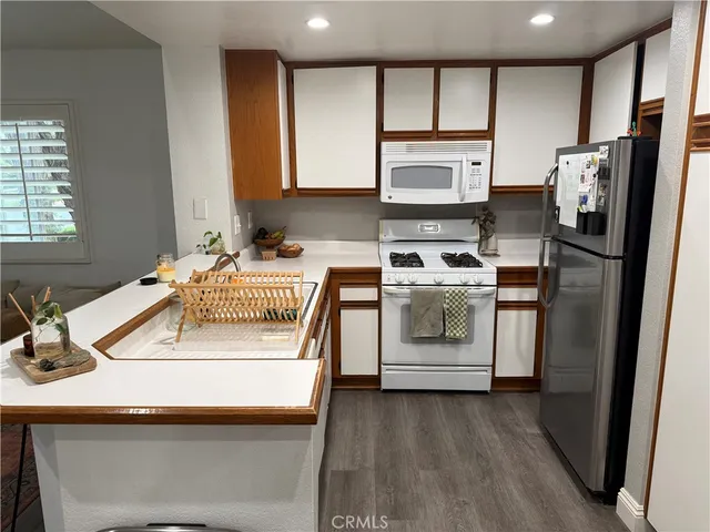 a kitchen with a sink stove and refrigerator
