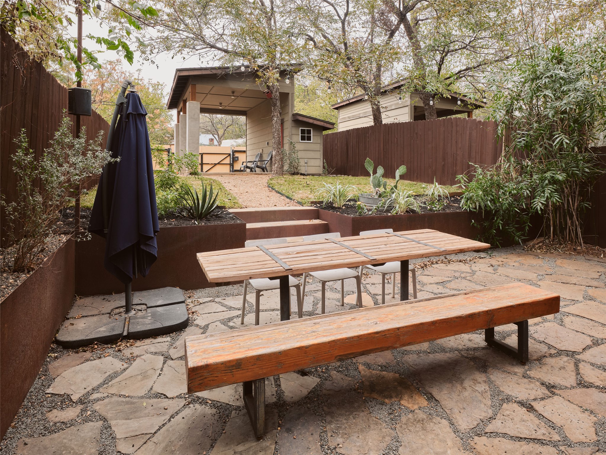 2002 East 13th Street, Unit A Austin, TX 78702 - Photo 37 of 37 Fenced backyard with a patio area and a storage unit