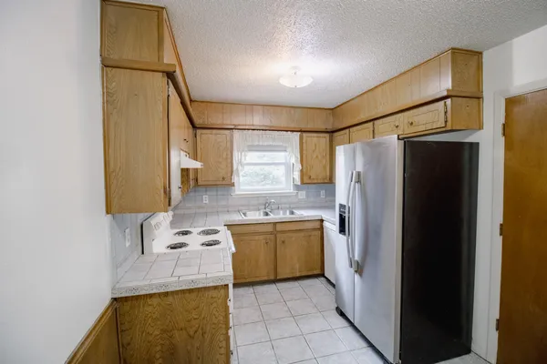 a kitchen with a sink appliances and cabinets