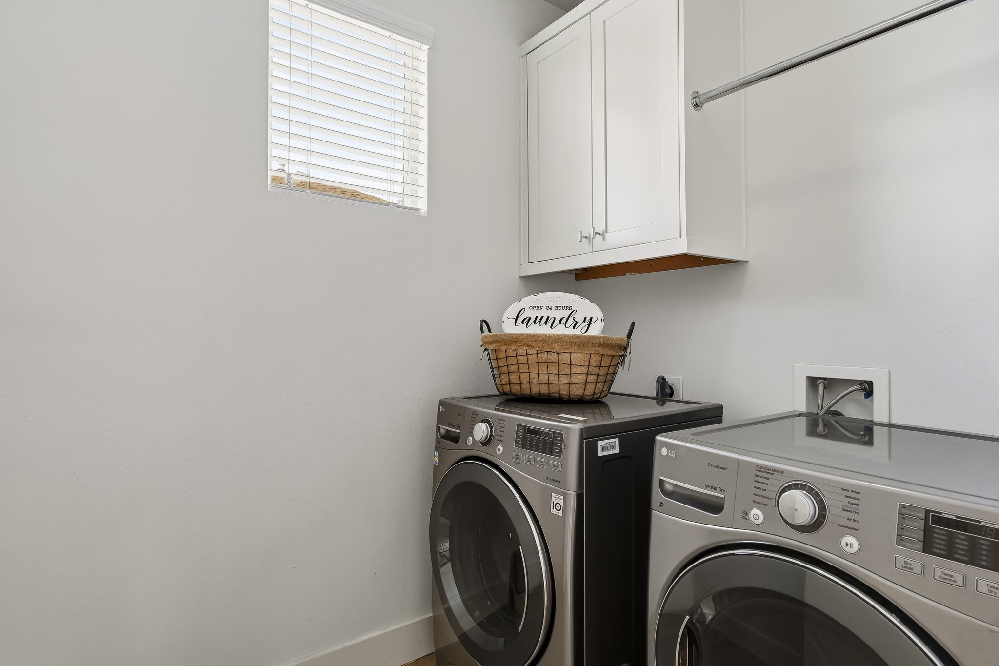 2004 Rosedale Street, Unit D Houston, TX 77004 - Photo 37 of 45 Conveniently positioned between the primary and secondary bedrooms, the utility room features tile flooring, a built-in storage cabinet, hanging rod and a window with blinds for natural light. The LG washer and dryer remain with the home and both electric and gas dryer connections provide added flexibility.