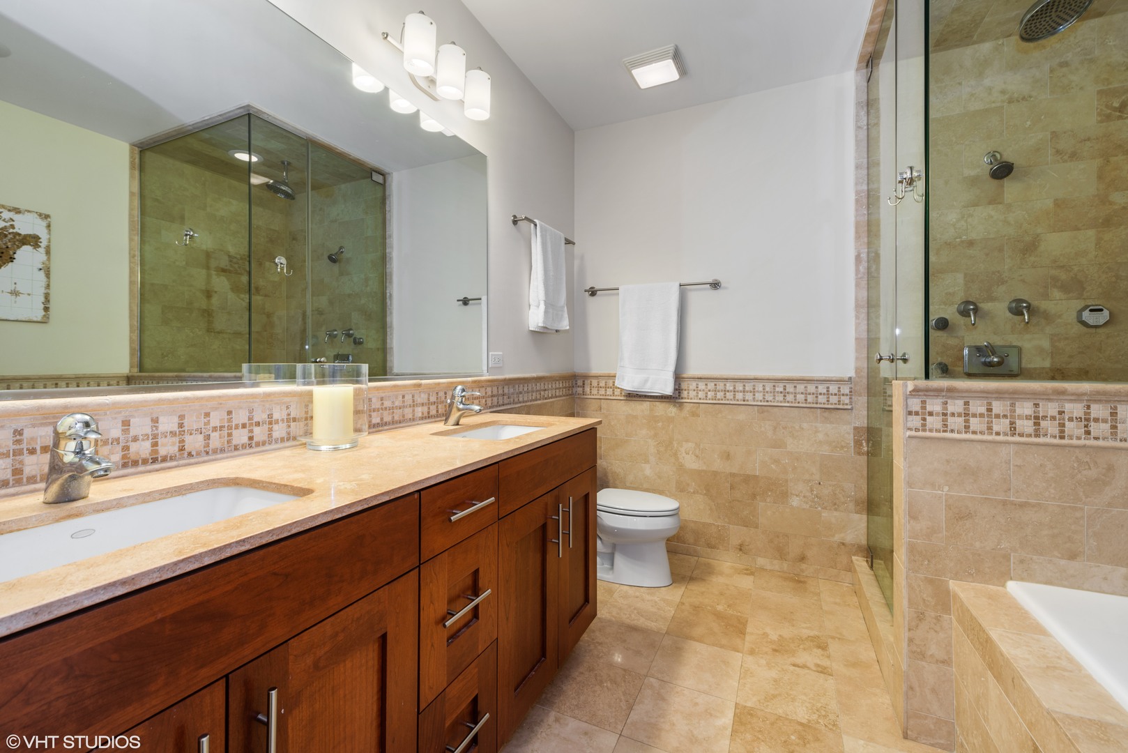 1025 West Monroe Street, Unit 3E Chicago, IL 60607 - Photo 11 of 14 a bathroom with a sink a toilet a large mirror and shower