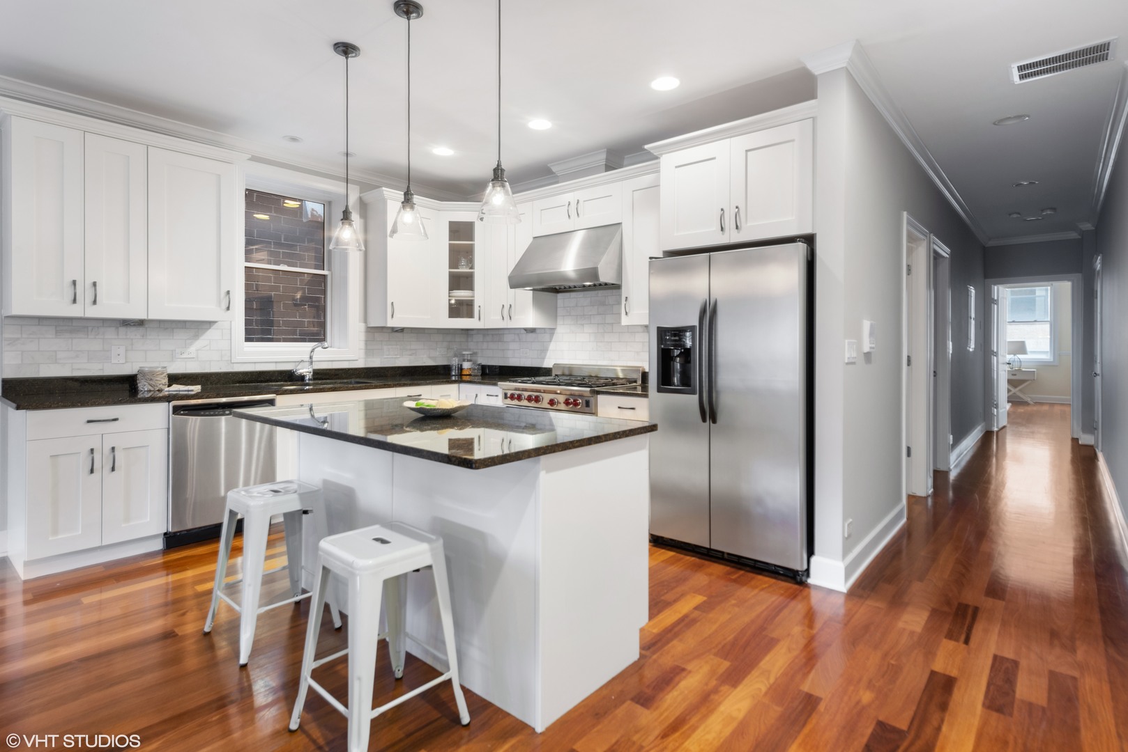 1025 West Monroe Street, Unit 3E Chicago, IL 60607 - Photo 6 of 14 a kitchen with granite countertop a refrigerator a sink a stove and white cabinets