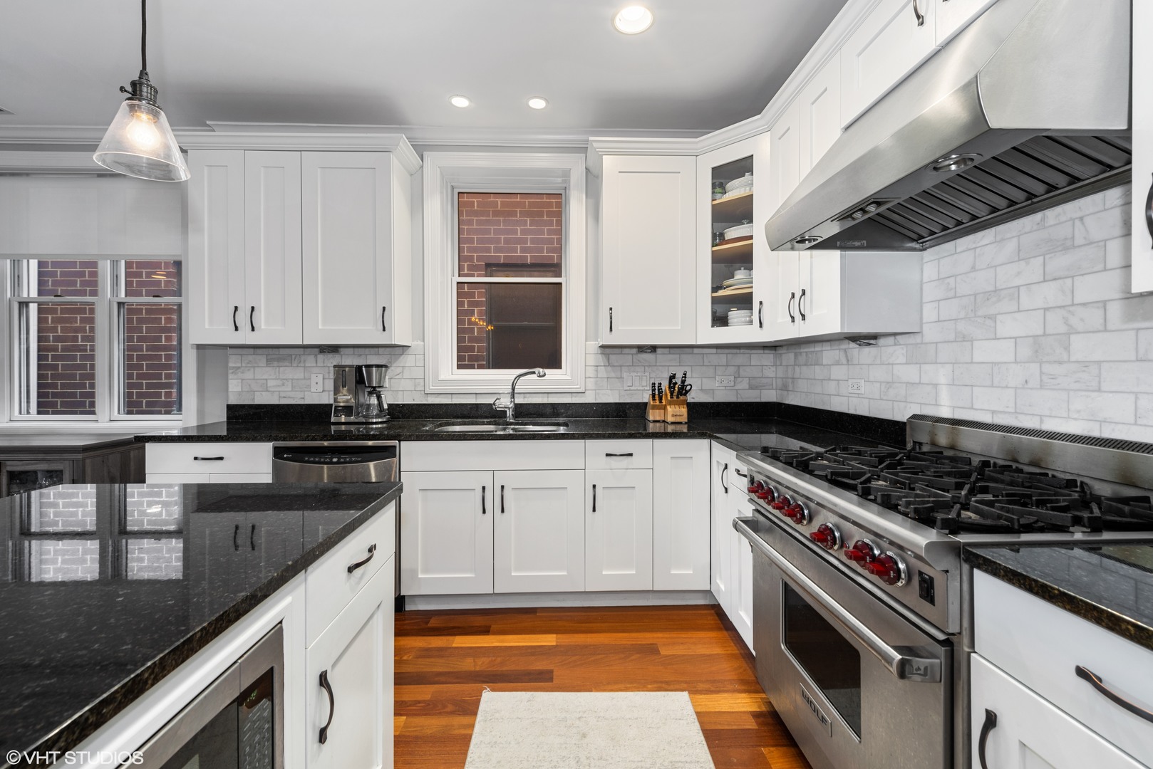 1025 West Monroe Street, Unit 3E Chicago, IL 60607 - Photo 7 of 14 a kitchen with stainless steel appliances granite countertop a stove a sink and a granite counter tops