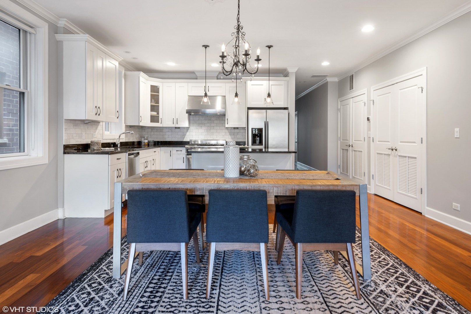 1025 West Monroe Street, Unit 3E Chicago, IL 60607 - Photo 8 of 14 a kitchen with stainless steel appliances kitchen island granite countertop a sink and cabinets