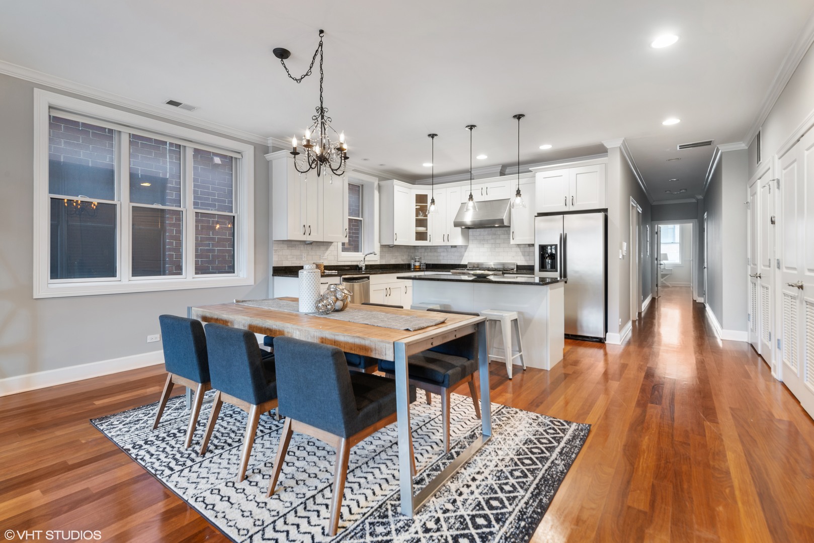 1025 West Monroe Street, Unit 3E Chicago, IL 60607 - Photo 9 of 14 an open kitchen with a table and chairs in it