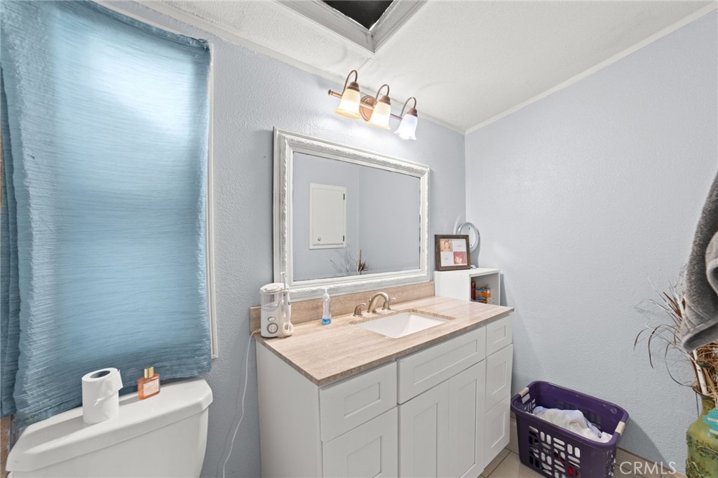 1155 South Riverside Avenue, Unit 22 Rialto, CA 92376 - Photo 21 of 34 a bathroom with a sink and a mirror