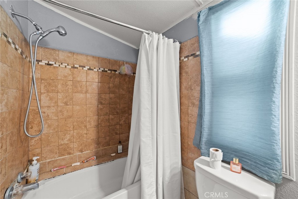 1155 South Riverside Avenue, Unit 22 Rialto, CA 92376 - Photo 22 of 34 a bathroom with a shower and a sink