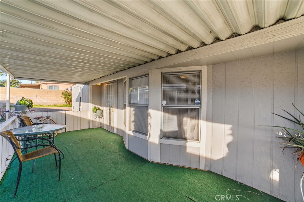 1155 South Riverside Avenue, Unit 22 Rialto, CA 92376 - Photo 5 of 34 a view of a patio with table and chairs and wooden fence
