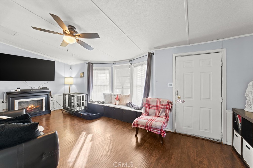1155 South Riverside Avenue, Unit 22 Rialto, CA 92376 - Photo 9 of 34 a living room with furniture and a flat screen tv
