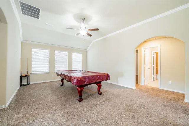 a spacious bedroom with a bed and a chandelier